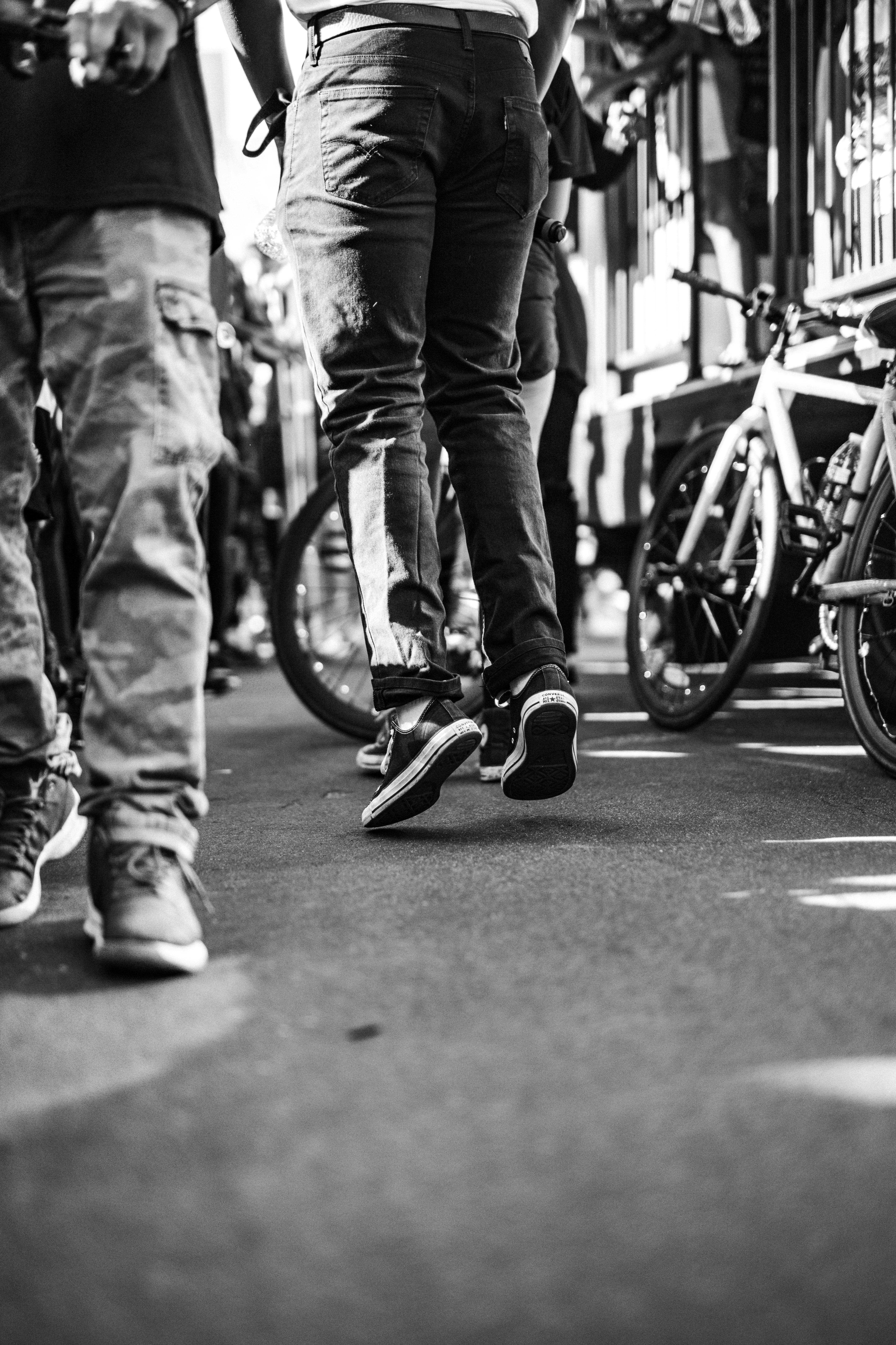 grayscale photo of man riding bicycle